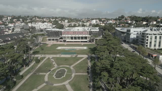 Aerial footage over a neighborhood around Gardens of Casino Estoril in Estoril, Portugal