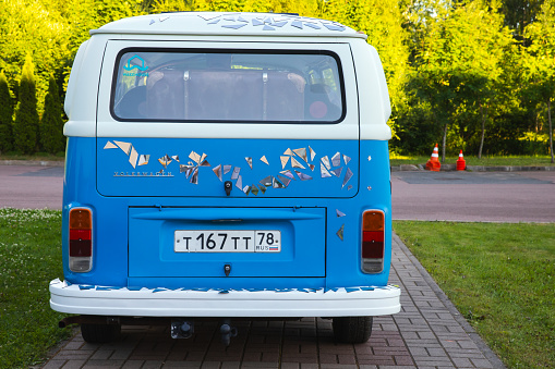 St-Petersburg, Russia - July 1, 2021: Blue white Volkswagen Transporter T2 bus stands parked on a cobbled lane, rear view