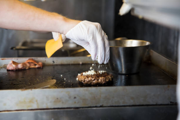 istock Chef cooking hamburgers 1650300924