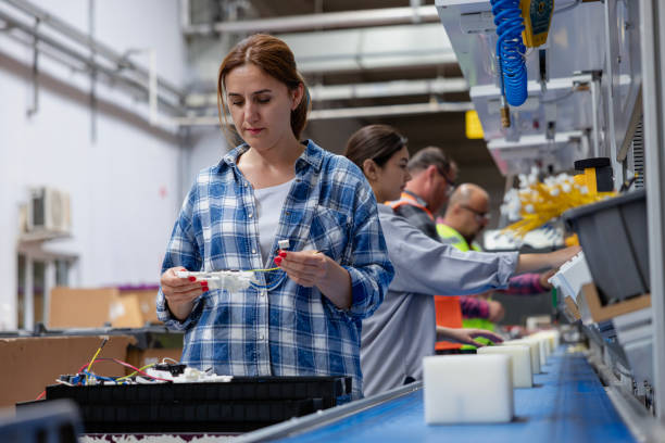 group of workers working on the production line in factory - electric plug electricity women power imagens e fotografias de stock