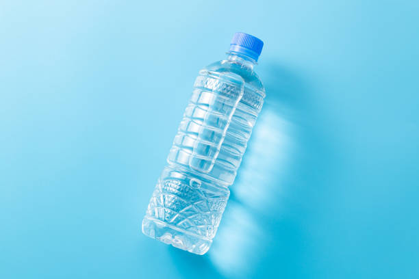 istock Bottled water on blue background. 1650316226