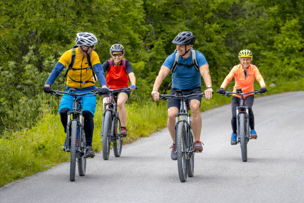 istock Couples riding electric bikes on road 1650330713