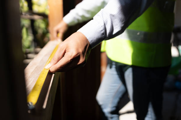 istock inspector or engineer is inspecting construction and quality assurance check dimension of house by using a tape measurement. Engineers or architects or contactor work to build the house before sell. 1650348684