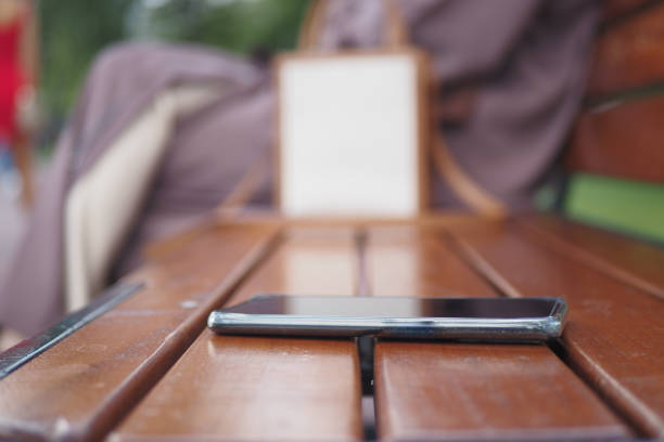 istock forget smartphone on a park bench, lost smart phone 1650378622