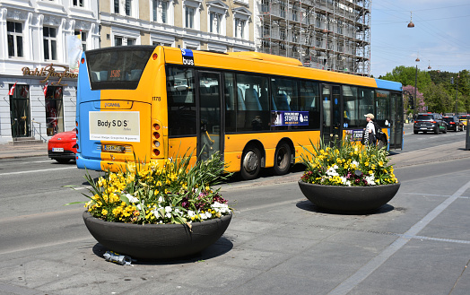 Copenhagen, Denmark - May 15, 2023: Scene Of Building Exterior, Public Transportation Bus, People Riding Bicycle, Walking And More During Springtime
