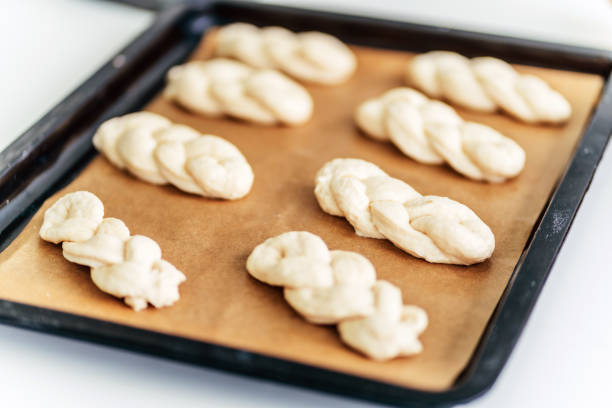 Group of braided challahs on parchment paper
