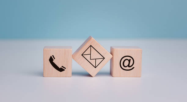 istock Customer support hotline Contact us people connection. cube wood with the email, call phone, address, and Chat message icons. Website page contacts us or e-mail marketing concept, copy space. 1650427517
