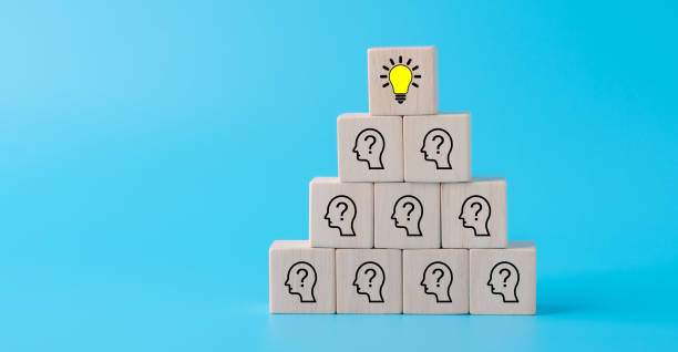 istock Creative idea and innovation concept with Wooden cubes with icon light bulb and human symbol on blue background. 1650427540