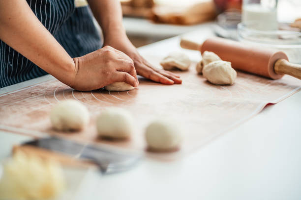 istock Female pastry chef prepares bread dough 1650428608