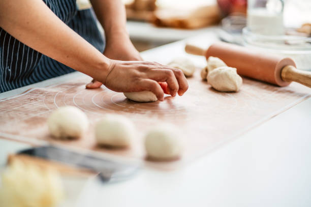 istock Female pastry chef kneading bread dough 1650429125