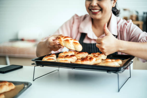 Female baker holding bread