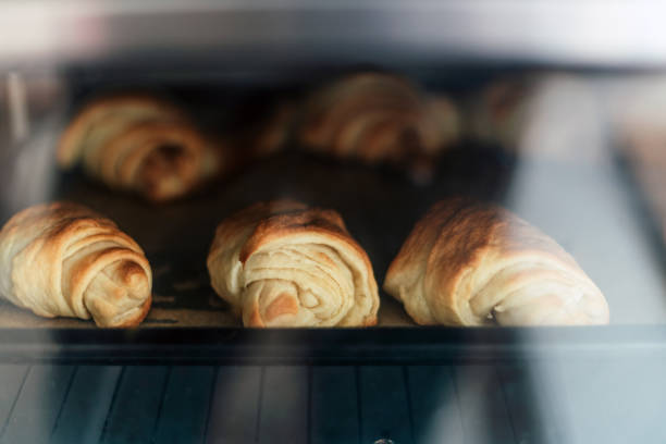 istock Home made wholemeal rolls baking in the oven 1650448750