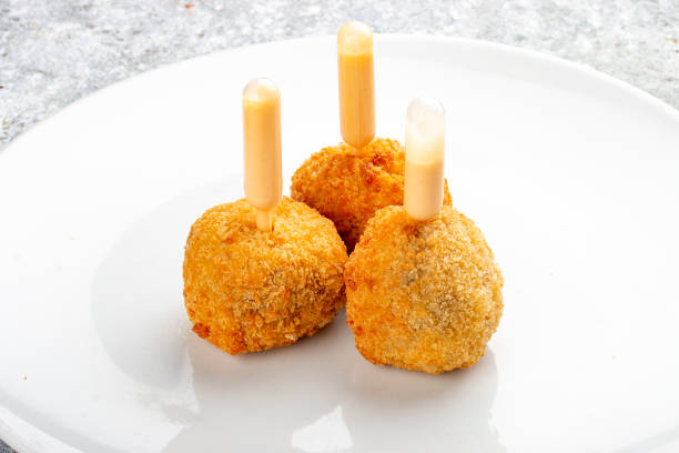 istock Cheese balls deep-fried with white sauce. Isolated image on a white background. 1650456716