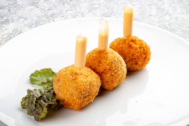 istock Cheese balls deep-fried with white sauce. Isolated image on a white background. 1650456722