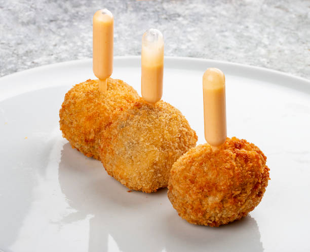 istock Cheese balls deep-fried with white sauce. Isolated image on a white background. 1650456733