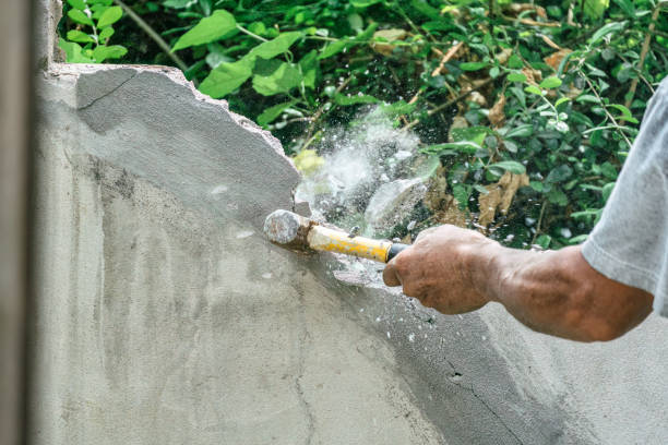 istock Hand of worker using hammer smashing and demolish on brick wall at construction site 1650482036