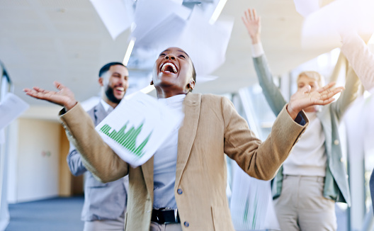 Documents in air, celebration and business people dance in office for achievement, winner and goals. Teamwork, collaboration and excited men and women dancing, throw paperwork and winning for success