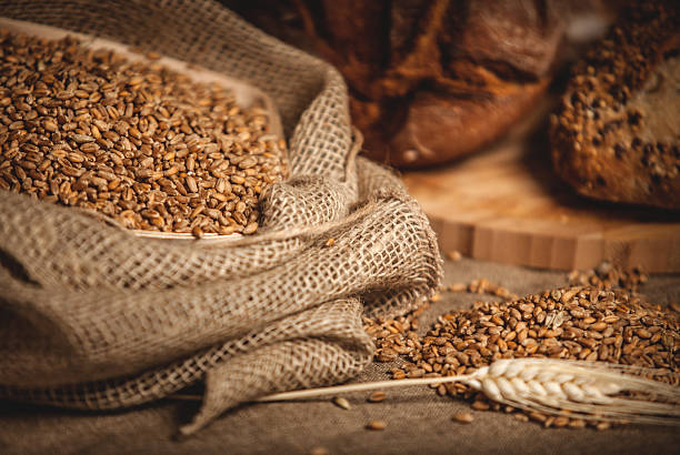 Sack of grain and bread on the background.
