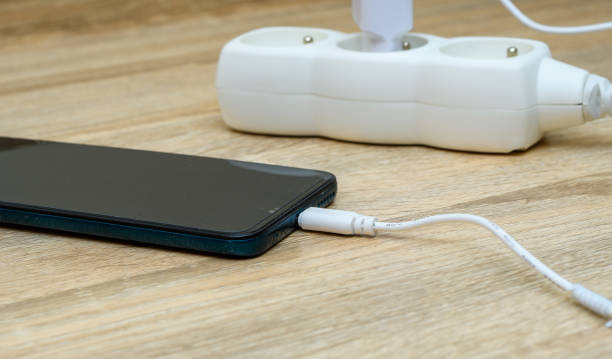 istock Charging a mobile phone with a cable connected to the power supply 1650501611