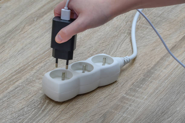 istock Phone charger plug connected to an extension cord 1650501616