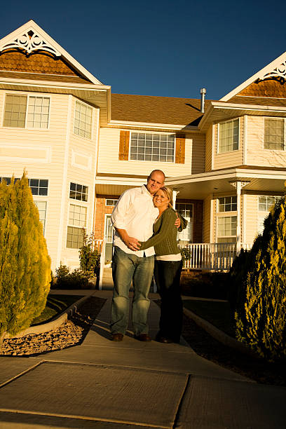 Married couple at home series XXL Young couple holding each other at home at sunset. mormon woman photos stock pictures, royalty-free photos & images