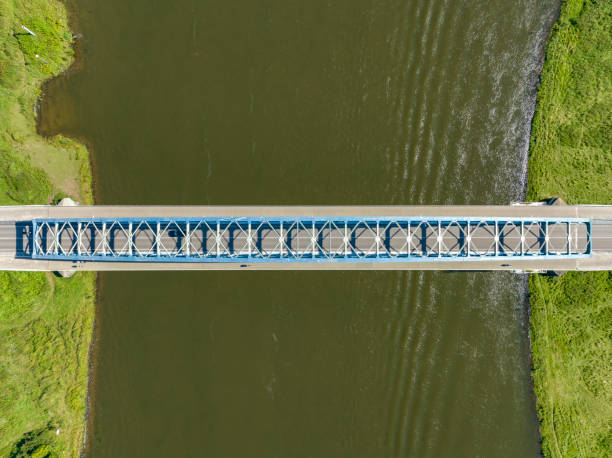 istock Road over and arch bridge crossing a river seen from above 1650510277
