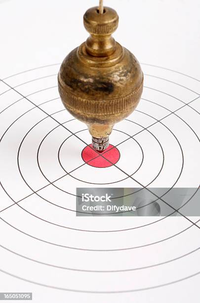 Target With Old Brass Plumb Bob Pendulum Over Centre Stock Photo - Download Image Now
