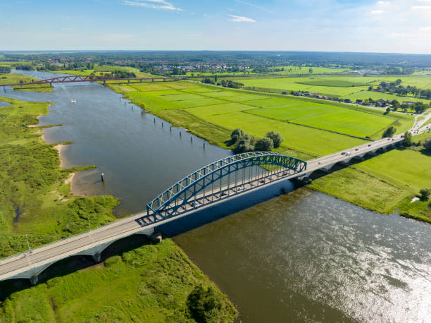 istock Road over and arch bridge crossing a river seen from above 1650512193