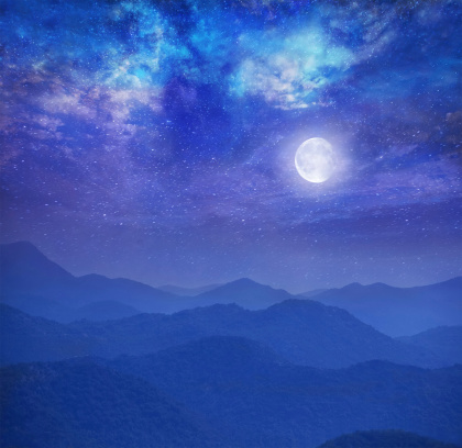 Galaxy with moon in mountains