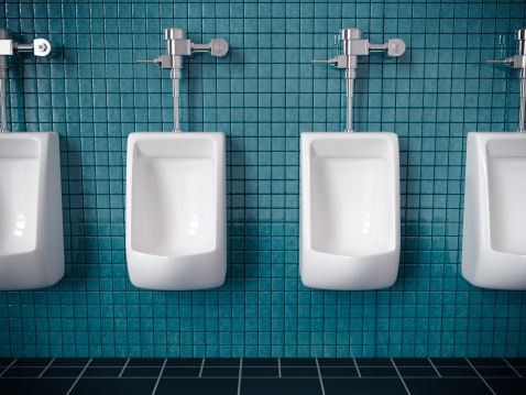 Four urinals on a blue tiled wall in public restroom.  Very high resolution 3D render.
