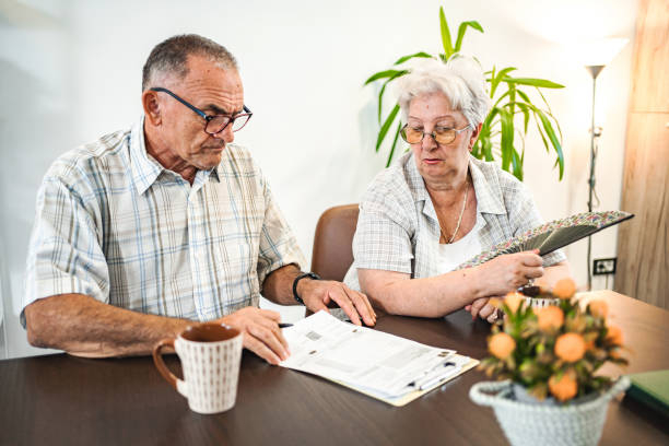 istock Married senior couple doing home finances together at home 1650527162