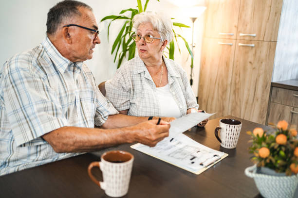 istock Affectionate married senior couple doing home finances together at home 1650527698