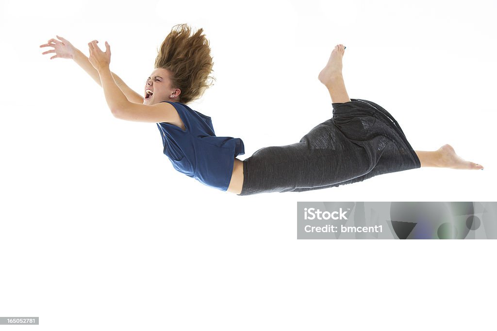 Woman falling (isolated on white) Studio shot, in camera isolation, of a young woman falling through mid-air. Great design element. Falling Stock Photo