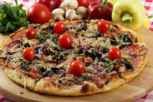 Baked pizza arranged on bamboo support stock photo