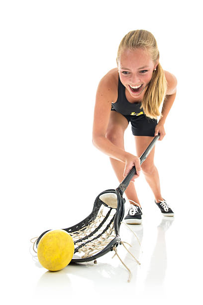 Girls Lacrosse Player Fields Ball, Studio Isolated Action Shot stock photo