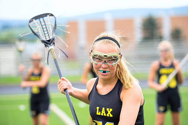 Intense look from female lacrosse player stock photo