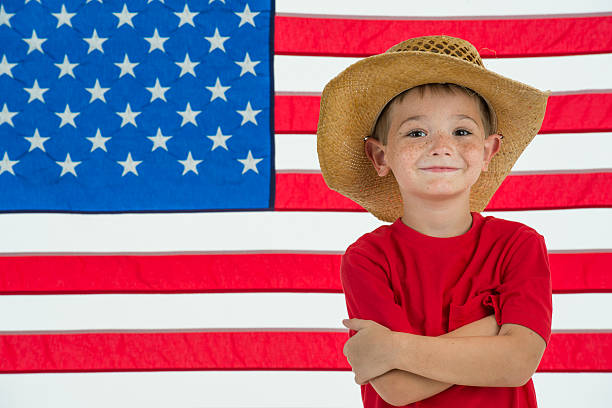 istock Patriotic Farm Boy with American Flag Background 165052914