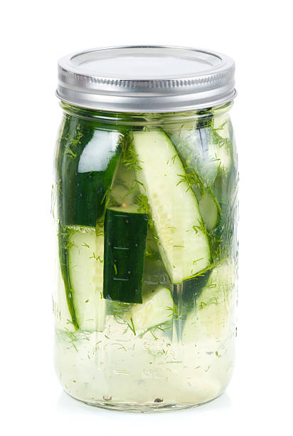Farm Fresh Quick Pickles with Dill Delictable jar of home made quick pickles with fresh cucumbers and dill herb from a local consumer supported agriculture (CSA) farm co-op. Simply put sliced cucumbers in a jar with vinegar, water, salt, and herbs and refridgerate overnight. Yum! dill pickle stock pictures, royalty-free photos & images