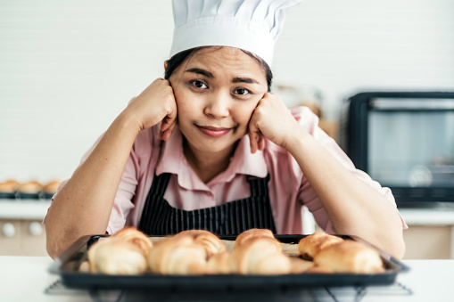Female pastry chef feeling failure making bread in bread kitchen