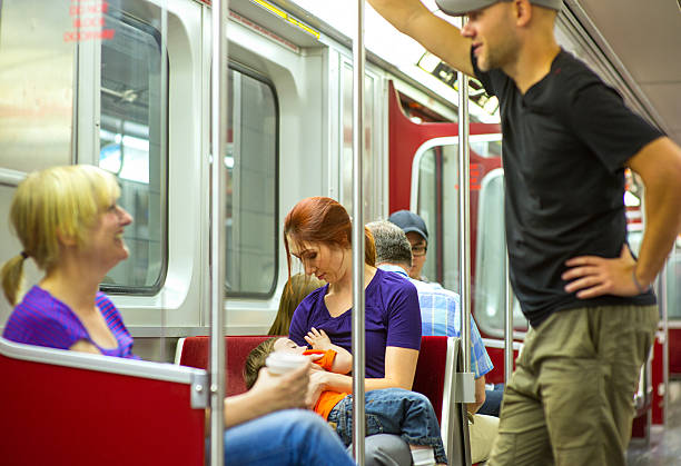 Mother Nursing Little Boy on Subway stock photo