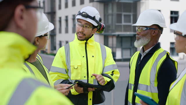 Tablet, planning and a designer team on a building site outdoor for a project management meeting. Technology, teamwork or discussion with an engineer, architect and construction worker talking safety