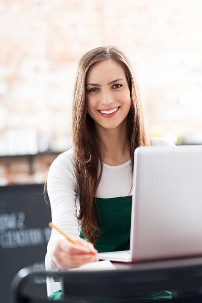 istock Young woman using laptop in cafe 165054233