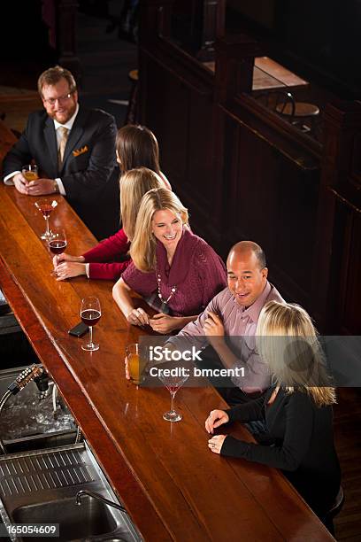 People Enjoying Drinks At Nightclub Bar Stock Photo - Download Image Now - Bar Counter, High Angle View, 20-29 Years