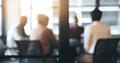 Business people, meeting and corporate discussion against a blurred background at the office. Group of employees in team planning, presentation or training staff for collaboration at the conference