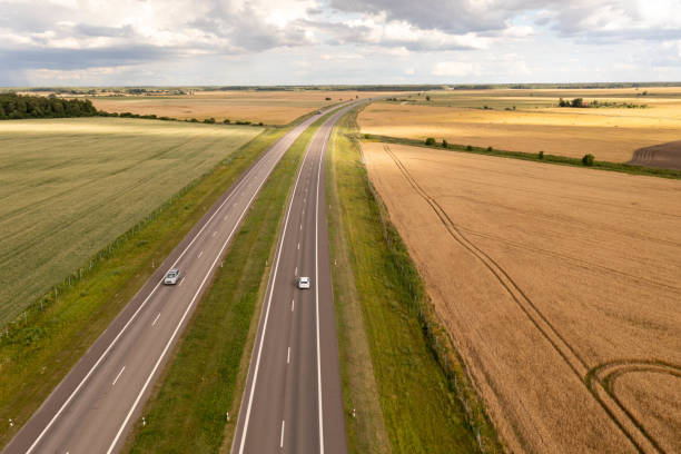 istock Drone photography of highway surrounded by agriculture fields 1650556767
