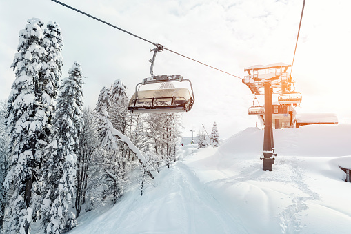 Cable car above the fog on the way to the top of the ski slope.