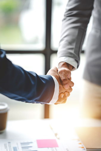 business partner handshake concept Colleagues shaking hands Successful deal after a great meeting. Blurred background.