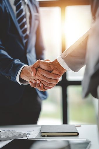 business partner handshake concept Colleagues shaking hands Successful deal after a great meeting. Blurred background.