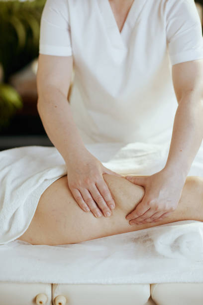 istock Closeup on medical massage therapist massaging clients leg 1650570211