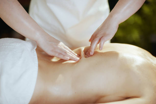 istock Medical massage therapist in spa salon massaging client 1650570219